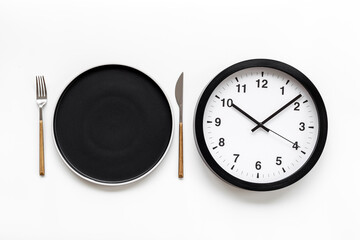 Time to eat - meal time concept. Round wall clock with plate
