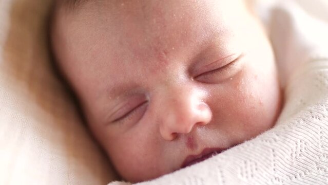 little girl newborn sleeping. portrait a baby close-up sleeping in bed indoors. maternity hospital continuation of the family concept. lifestyle newborn baby sleeping face cute portrait