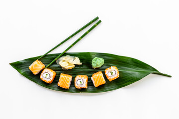 Salmon sushi rolls set on Bamboo leave, top view. Eco serving