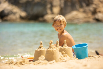 Happy child on the beach, enjoying summer, playing