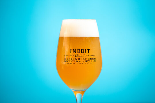 14 July 2022, Close-up details of a glass of INEDIT by Damm Beer with a Summer Blue Background, Braga, Portugal.