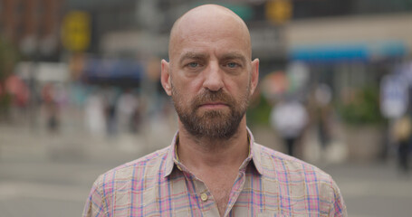 Caucasian middle aged man serious angry face portrait in city