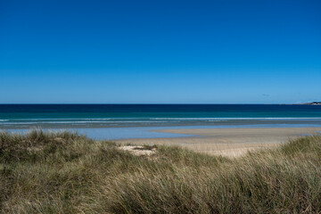 Fototapeta na wymiar Sandy beach with dunes