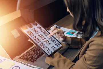 Woman accountant use calculator and computer with holding pen on