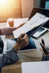 Woman accountant use calculator and computer with holding pen on