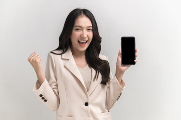 Portrait photo of young beautiful Asian woman feeling happy or surprise shock and holding smart phone with black empty screen on white background can use for advertising or product presenting concept.