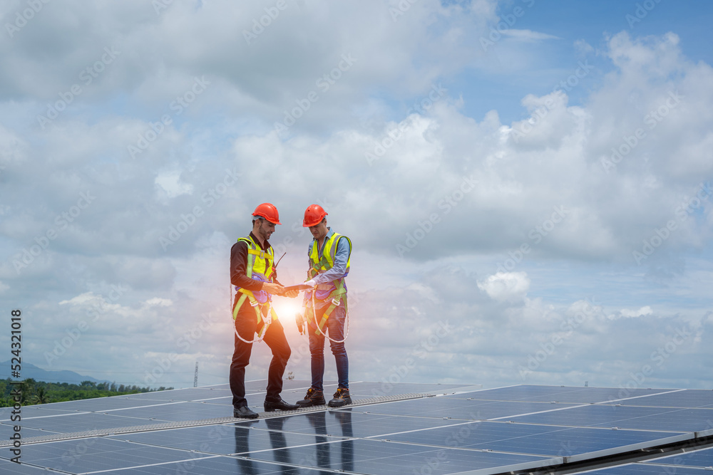 Poster Professional worker installing and checking solar panels on the roof of a factory,Innovative solution for energy solving. Use renewable resources. Green energy.
