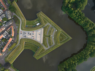 Fortified ancient old historic town of Naarden Vesting overhead aerial drone view of monumental ancient fort at the Zuiderwaterlinie medieval fortress defenisive vest landmark in The Netherlands.