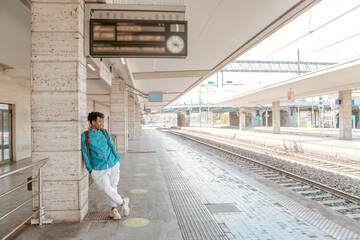 Guy standing on railway platform looking aside