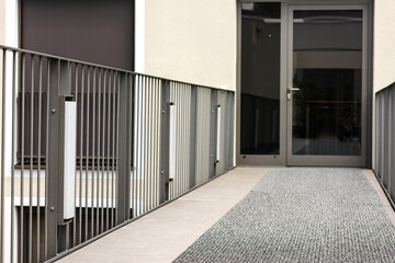 Entrance Door from Balcony or Terrace with Railings. Modern Glass Entrance Door of Residential Building.  