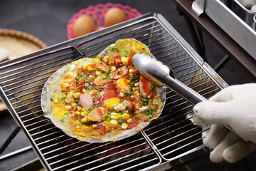 Vietnamese rice paper pizza ( Banh Trang Nuong ), street food that originates from Da Lat, a city in Southern Vietnam