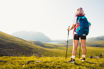 Close up young caucasian sporty woman hiker alone stand on viewpoint outdoors in sunny hot weather alone. Inspirational active strong woman sports activities outdoors