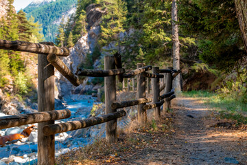 View of a wooden fence alongside a mountain torrent