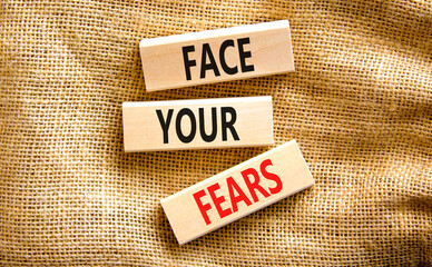 Face your fears and support symbol. Concept words Face your fears on wooden blocks on canvas....