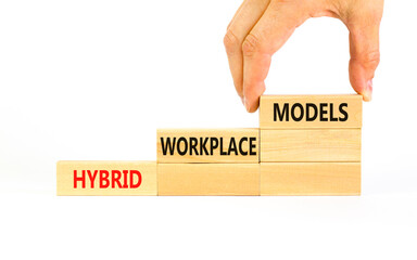 Hybrid workplace models symbol. Concept words Hybrid workplace models on wooden blocks. Businessman hand. Beautiful white background. Business hybrid workplace models quote concept. Copy space