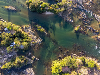 river bird top view with rocks, sand and forest