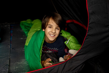 Children, sibilngs, sleeping in sleeping bags in a tent in Norway