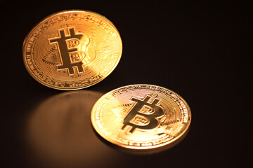 Bitcoin on a black background with reflection