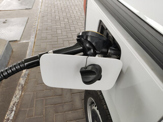 The car refuels in the gas tank. Close-up of filling the car with fuel