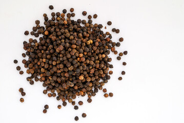 spices black pepper whole peas close-up on a white background