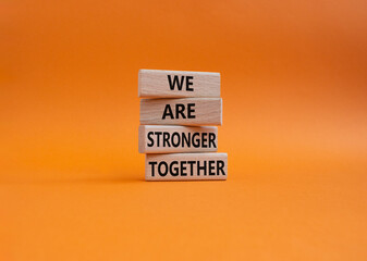 We are stronger together symbol. Wooden blocks with words We are stronger together. Beautiful orange background. We are stronger together concept. Copy space. - obrazy, fototapety, plakaty