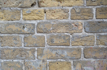 Wall of old yellow bricks. Vintage background.