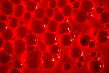 Bubble red background texture. Berry gel to cleanse the skin of the face and body. Spa treatments,...