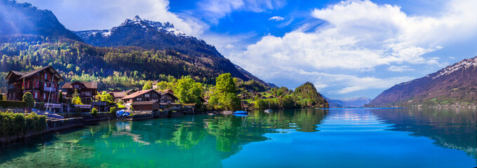Stunning idylic nature scenery of mountain lake Brienz. Switzerland, Bern canton. Iseltwald village surrounded turquoise waters