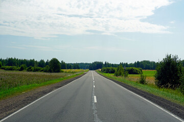 Rural landscape. The road through the fields and forests, stretching beyond the horizon. perspective lines