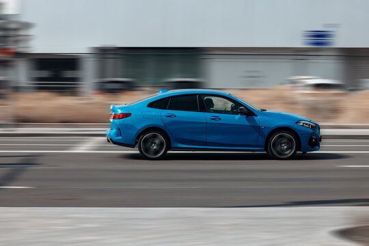 Blue Car BMW 2 Series Gran Coupe F44 Fast Moving On The Street, Side View