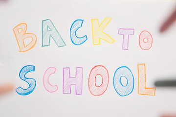 I don't want to go back to school. On white A4 paper sheet written words with different color pencils. Summer ending and new study year beginning.