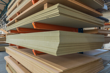 MDF sheet materials on cantilever rack in joinery workshop. - obrazy, fototapety, plakaty