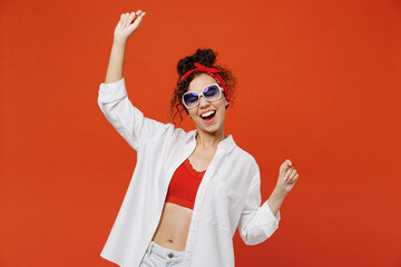 Young trendy happy woman of African American ethnicity 20s in white shirt red top sunglasses...