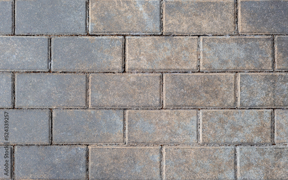 Poster Grey brick wall background close up. Gray stone tile block background with horizontal texture of gray brick. Gray brick surface