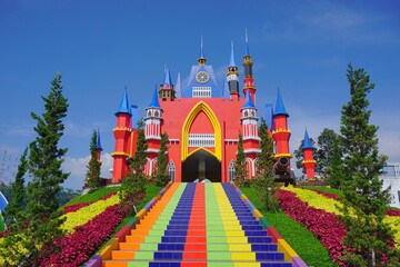 Colorful castle with stairs and flowers garden under blue skies. Florawisata dcastello Subang. One...