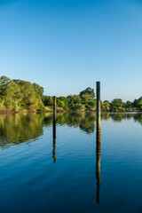 Two pilings in an inlet near the Atlantic Ocean on a sunny morning. 