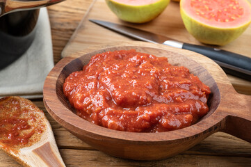 Goiabada, traditional brazilian creamy guava sweet with fruits over wooden table
