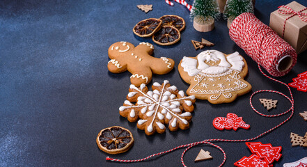 Christmas homemade gingerbread cookies on dark concrete table