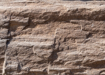 Rough brown texture made of natural stone, macro photo