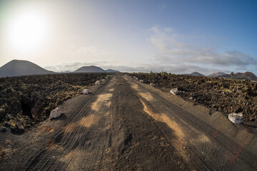 Typical volcanic landscape. Road going into the distance. Lanzarote, Canary Islands. Spain.