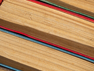 A macro of closed books with the texture of page leaves