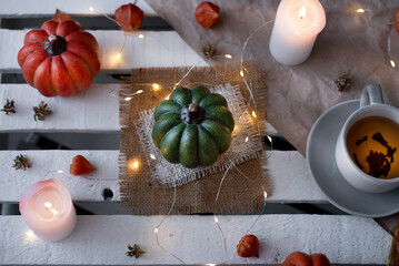 autumn decor of pumpkins and candles in october. idea for halloween