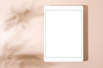 Blank screen tablet mock up and shadow on green pastel background. Copy space. Mock up template. Business communication. Isolated object. Spring decoration.