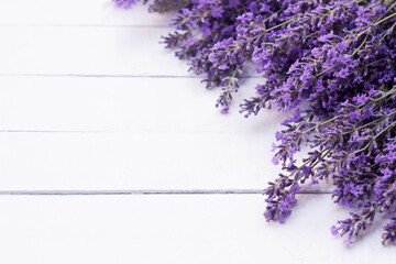 Fragrant lavender flowers on a white wooden background. Place for text