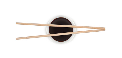 Soy sauce in white ceramic bowl and two bamboo chopsticks isolated on white background top view           