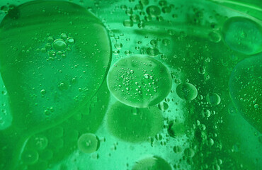 abstract green background formed by oil drops on water
