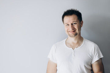 Handsome guy in a white t-shirt smiling