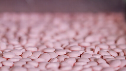 Process of production of pills, tablets. Industrial pharmaceutical concept. Factory equipment and machine.