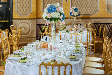 Wedding table setting. A table in a restaurant against the backdrop of a large window.