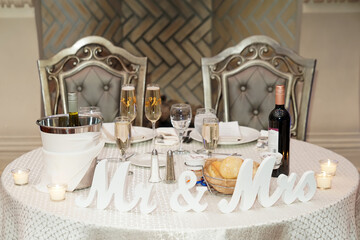 Wedding table setting. The letters Mr and Mrs at the wedding. Decorated table with letters and svachas. 	
